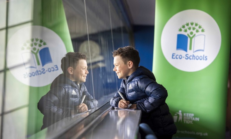 Photo of a child with the Eco-Schools Banner